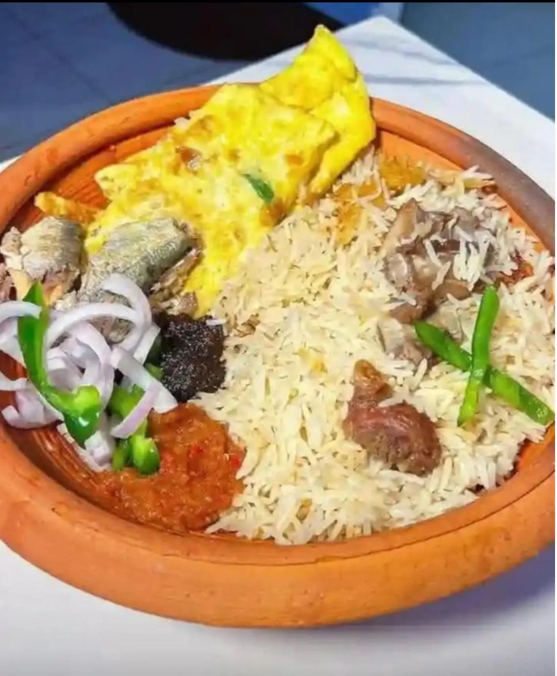 Angwamo — oil rice with omelette, fried fish and pepper