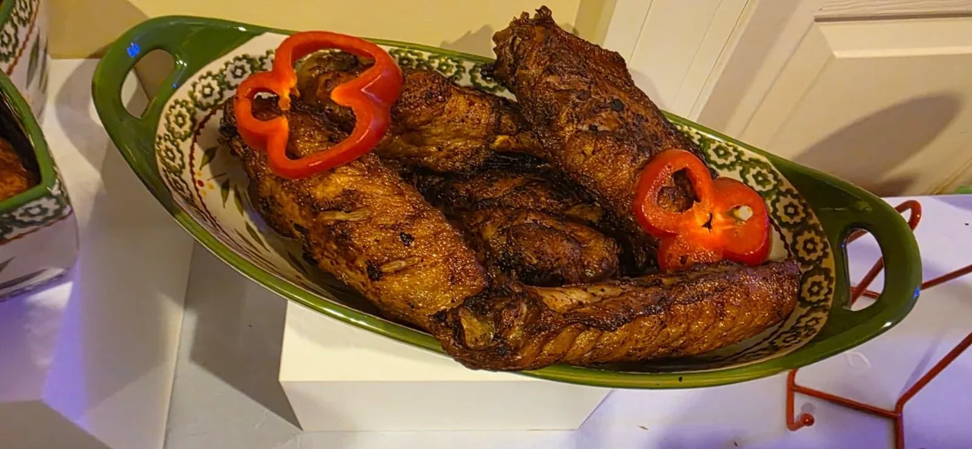A platter of grilled meat dressed with peppers