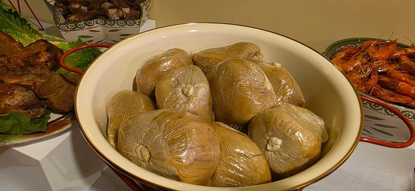 Kenkey wrapped and ready on a buffet table