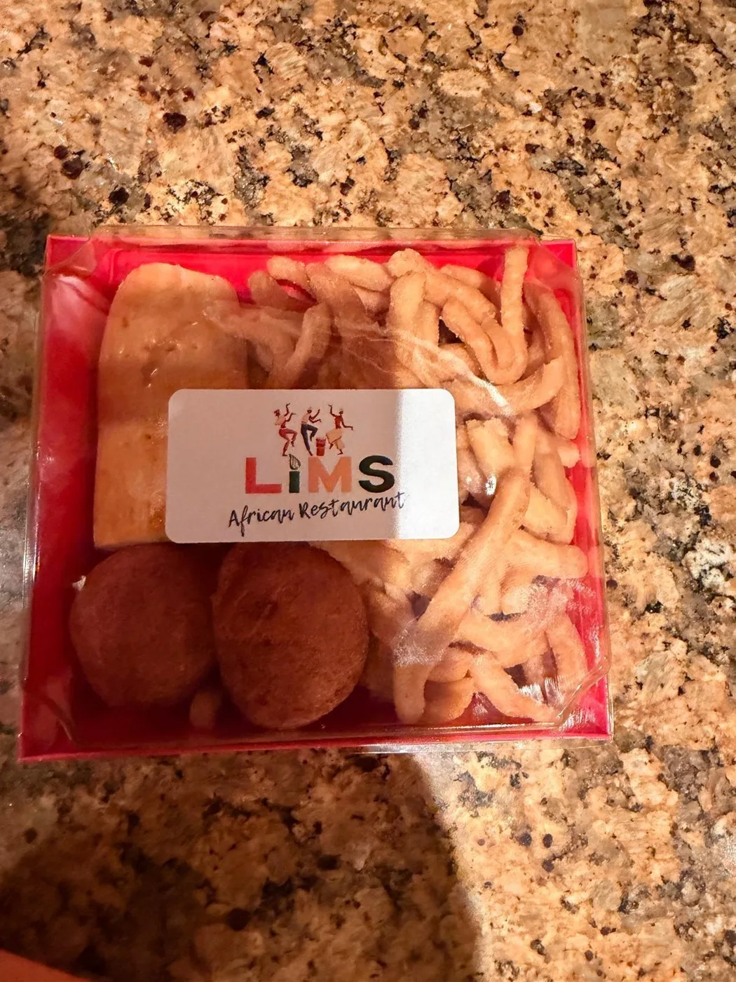 A LIMS-branded snack box of pastries and chin chin